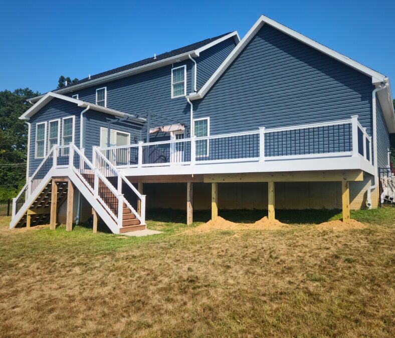 large composite deck with white railings on a single family home