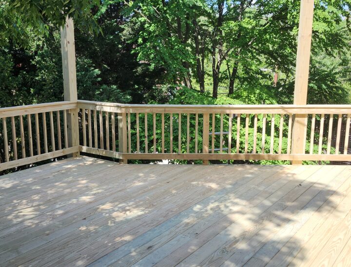 natural wood deck against a forest backdrop