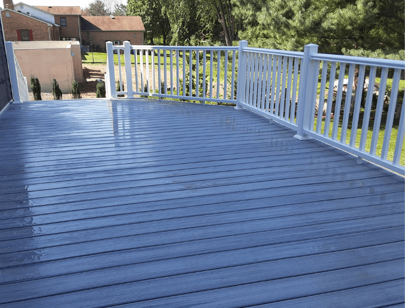 blue composite decking with white railings built by mount joy company